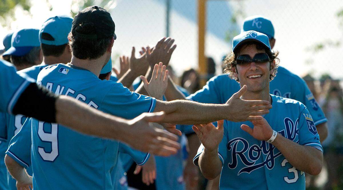 Paul Rudd ran down the line being congratulated after he scored on a home run by Kansas City Chiefs punter Dustin Colquitt during the 2011 Big Slick celebrity wiffle ball game at Kauffman Stadium.