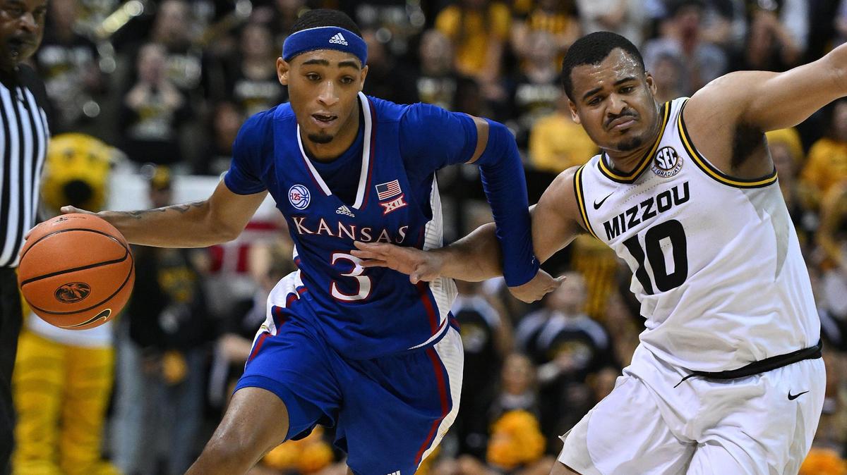 KU’s Dajuan Harris drives on MU’s Nick Honor during the first half of Saturday’s game at Mizzou Arena.