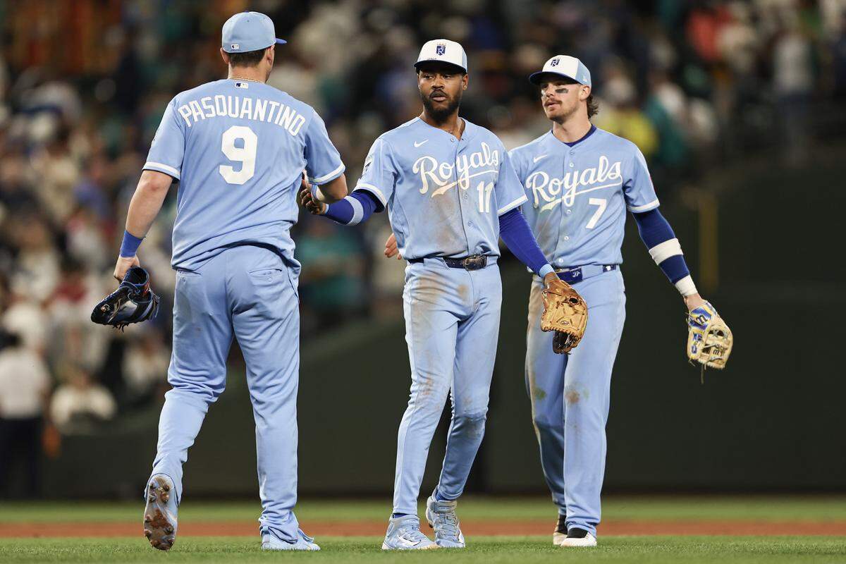 Maikel Garcia, center, high-fives Royals teammate Vinnie Pasquantino, left, after the Royals’ 10-inning win over the Mariners on Saturday, May 2, 2026 at T-Mobile Park in Seattle.