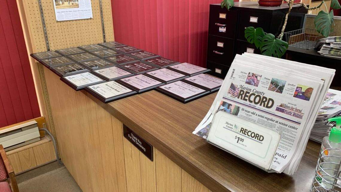 Marion County Record papers for sale in the newspaper’s office beside a collection of Kansas Press Association awards on Aug. 11, 2023, the day the office was raided by local law enforcement.