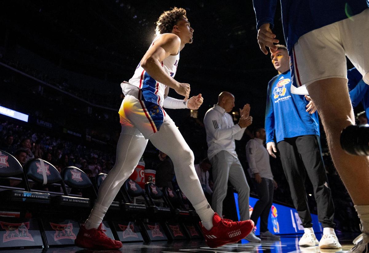 Kansas forward Jalen Wilson (10) runs onto the floor before an NCAA college basketball game against West Virginia in the second round of the Big 12 Conference tournament Thursday, March 9, 2023, in Kansas City.