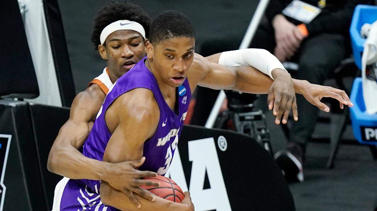 Texas’ Kai Jones, left, defends against Abilene Christian’s Joe Pleasant (32) during the first half of a college basketball game in the first round of the NCAA tournament at Lucas Oil Stadium in Indianapolis Saturday, March 20, 2021. (AP Photo/Mark Humphrey)
