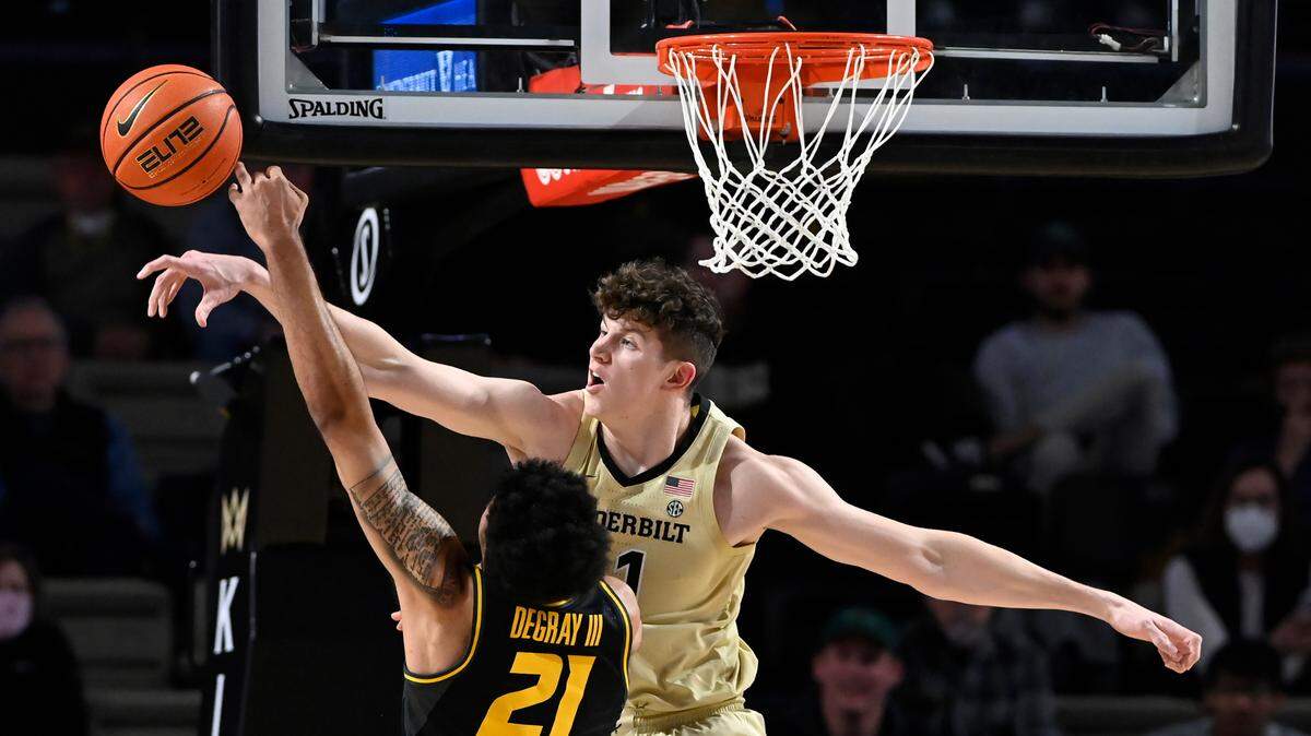 Vanderbilt center Liam Robbins, top, blocks a shot by Missouri forward Ronnie DeGray III (21) during the first half of an NCAA college basketball game Tuesday, Feb. 8, 2022, in Nashville, Tenn. (AP Photo/Mark Zaleski)
