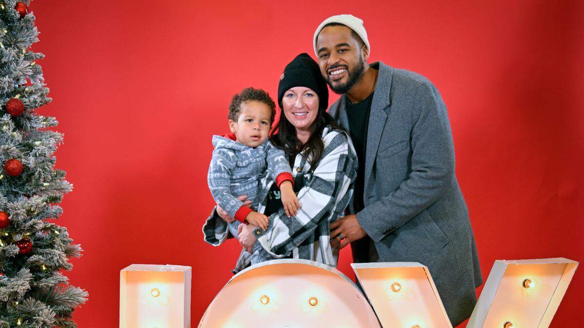 J. Ryan Lott and his family posing for their holiday portrait at the Soul of Santa community breakfast event.