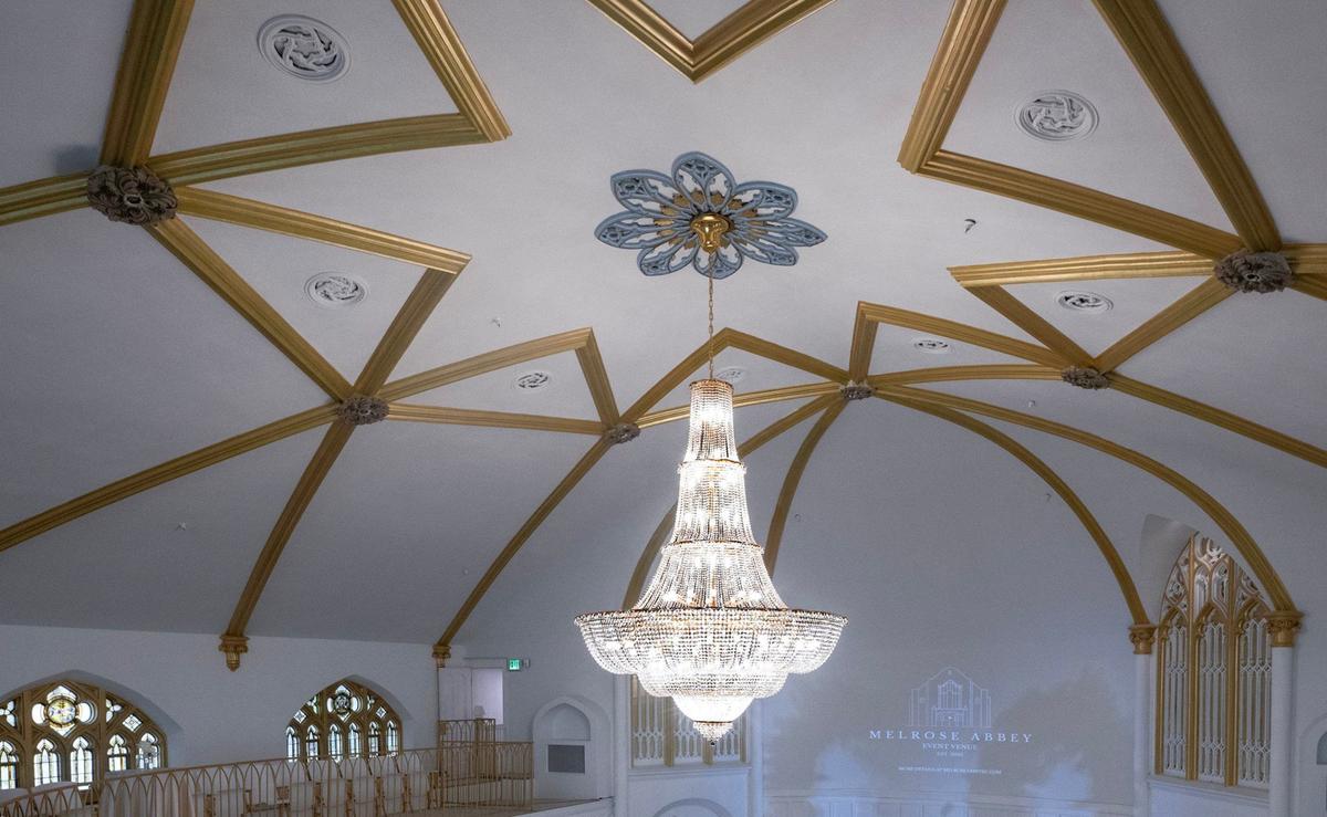 The crystal chandelier in the sanctuary at Melrose Abbey, the wedding and event venue created from the former Broadway Baptist Church in Westport.