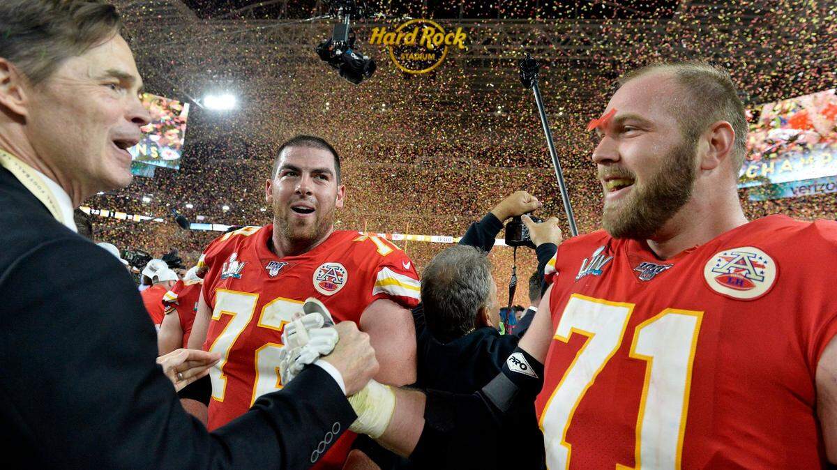 Kansas City Chiefs president Mark Donovan celebrates the Chiefs’ Super Bowl LIV victory in Miami with tackles Mitchell Schwartz (No. 71) and Eric Fisher on Feb. 2, 2020.