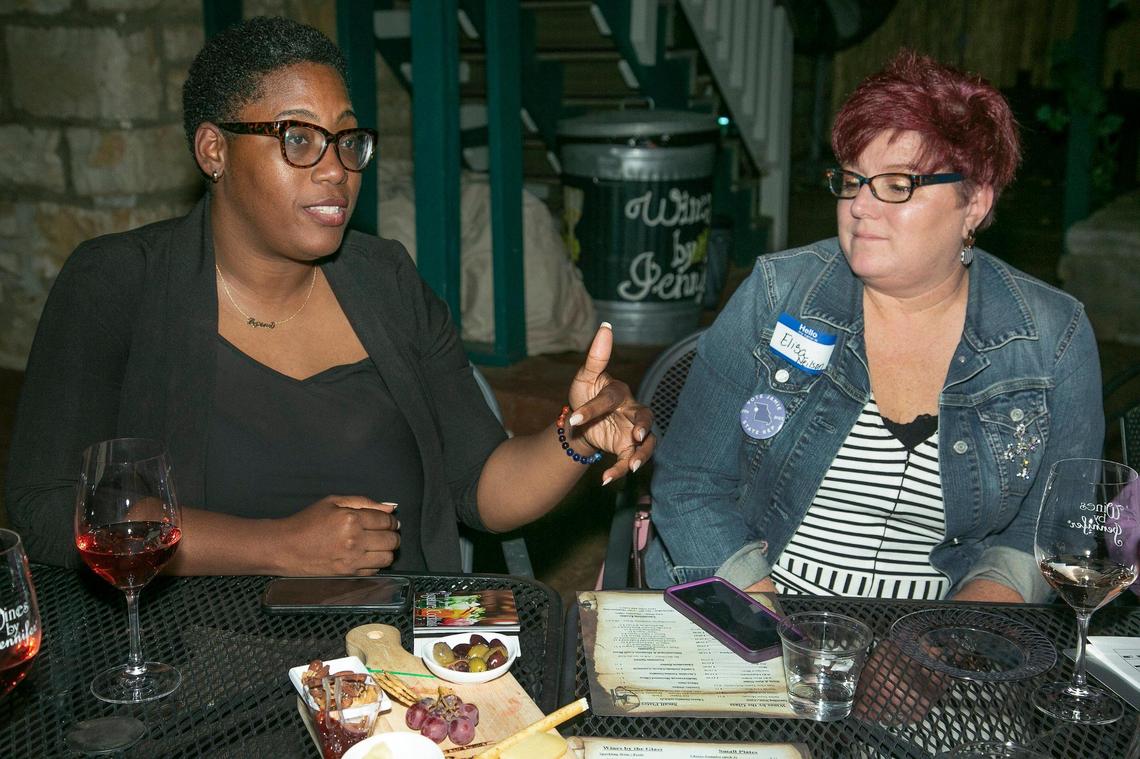 Jamie Johnson, left, Democratic candidate for District 12 of the Missouri House of Representatives, visited with Elisa Neilson during an October campaign event at Wines by Jennifer in Parkville.