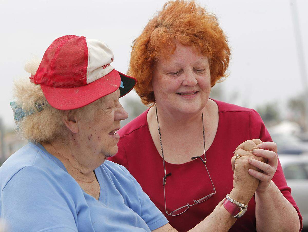 Kathrin Elmborg's wedding ring was found in the rubble of her home by Lana Nelson, right.
