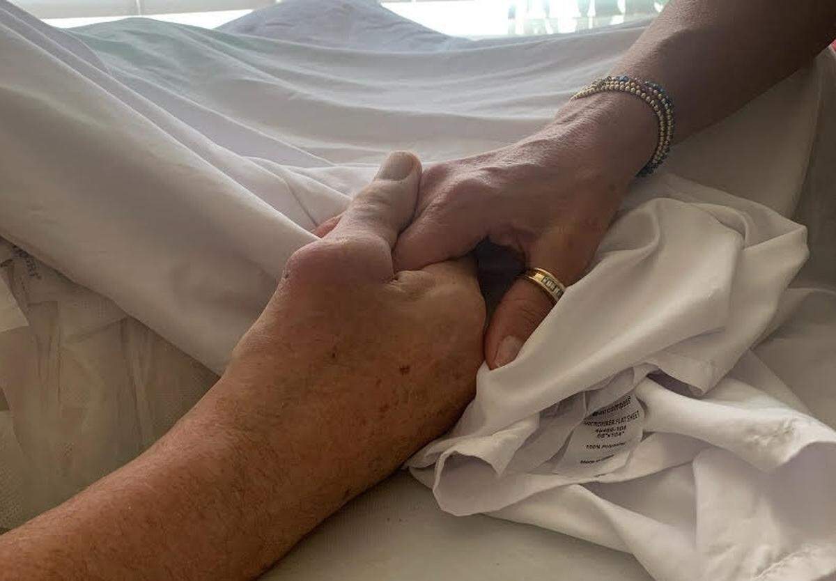 Ed Lothamer holds daughter Ryan’s hand in his final days.
