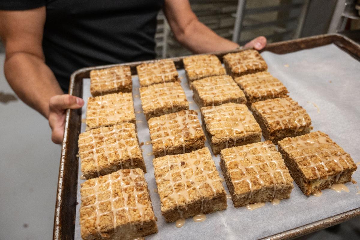 Brad Killen, owner and CEO of Scratch KC, holds a tray of coffee cakes. Killen started the company in 2013, in part because “I just saw the need for better cookies in Kansas City.” Now he plans to expand their reach even more.