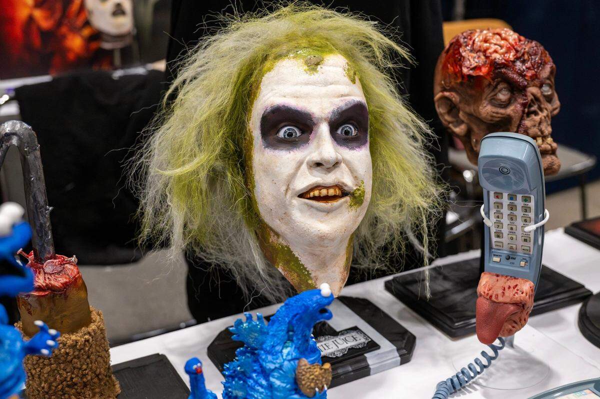 A bust of Beetlejuice is displayed alongside other busts at the Patrick Hart booth during Planet Comicon at the Kansas City Convention Center on Friday, March 21, 2025.
