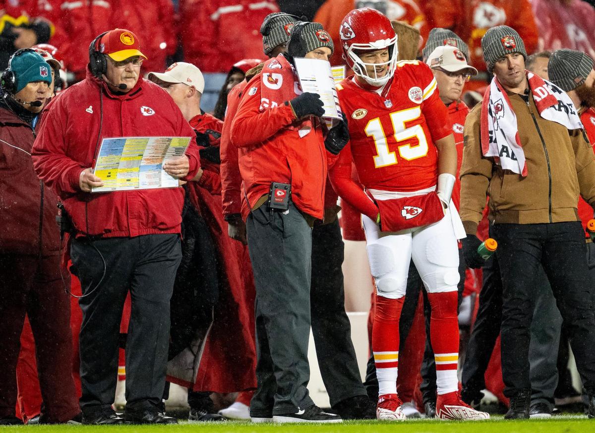 Chiefs quarterback Patrick Mahomes (No. 15) listens to offensive coordinator Matt Nagy while head coach Andy Reid, left, looks on during Monday night’s game against the Philadelphia Eagles at GEHA Field at Arrowhead Stadium.