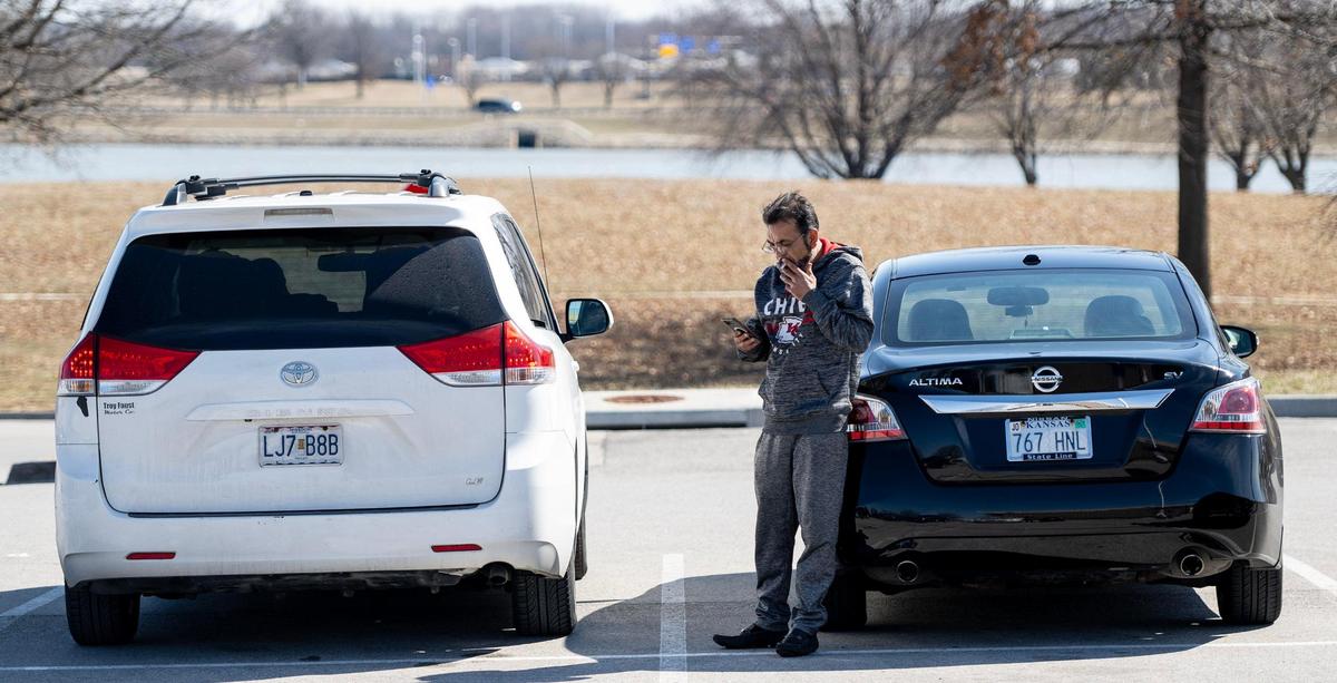 Sher Shah utilizes the Cell Phone lot while waiting for his brother’s flight to land at Kansas City International Airport on Sunday, March 5, 2023, in Kansas City.