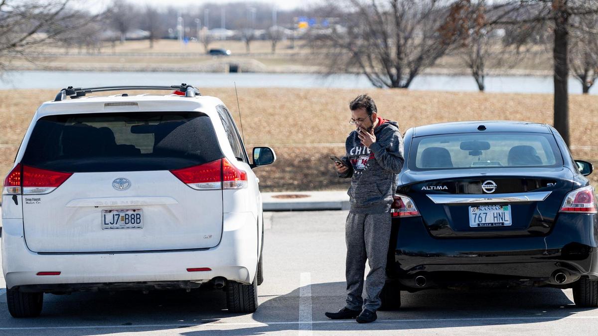 Sher Shah utilizes the Cell Phone lot while waiting for his brother’s flight to land at Kansas City International Airport on March 5 in Kansas City.