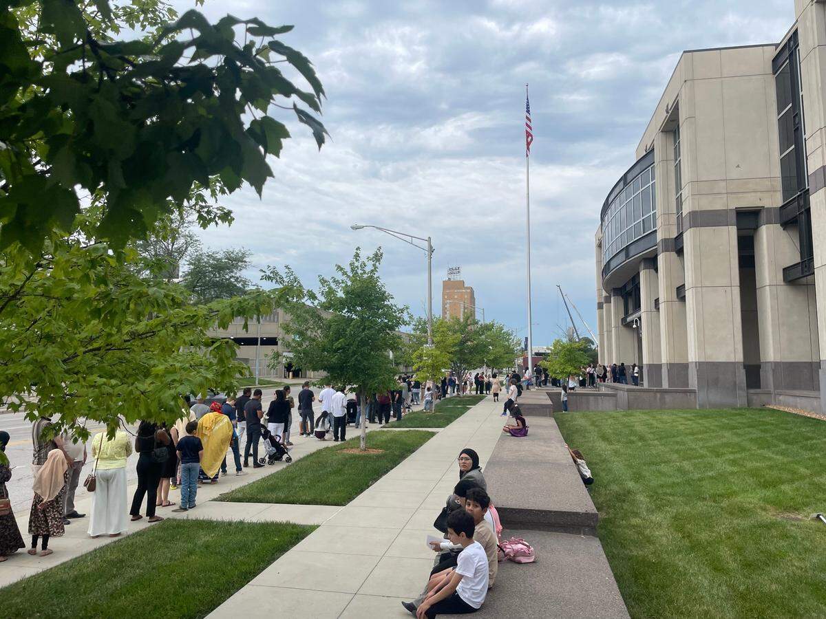 Family members and loved ones line up outside a federal courthouse in downtown Kansas City, Kansas, ahead of a mid-morning naturalization ceremony on June 17, 2025.