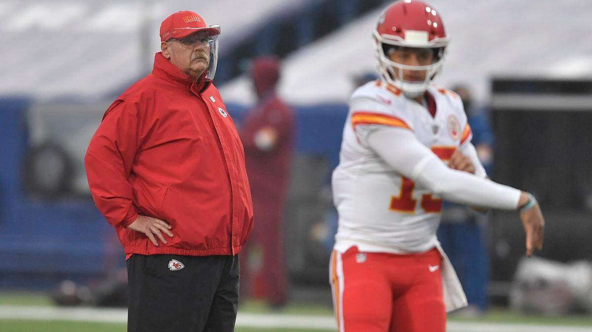 Chiefs coach Andy Reid, left, watches Patrick Mahomes during warm-ups before Monday’s game against the Buffalo Bills in Orchard Park, N.Y.