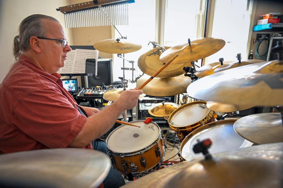 Tom Kuhn, a drum line and percussion coach at De Soto High School, plays the drums at his home. “I’m for anything that brings jobs here,” said Kuhn, who has lived in De Soto since 1975.