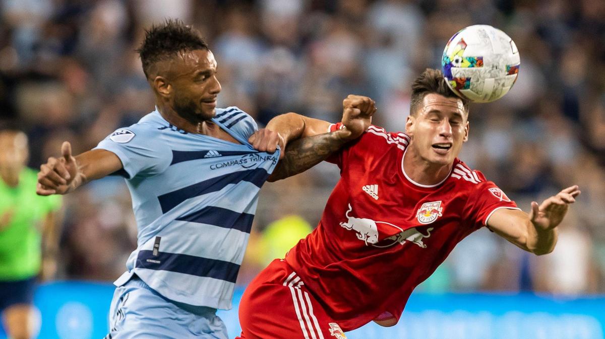 New York Red Bulls defender Sean Nealis, right, elbows past Sporting Kansas City forward Khiry Shelton during Sunday’s match at Children’s Mercy Park in Kansas City, Kansas.