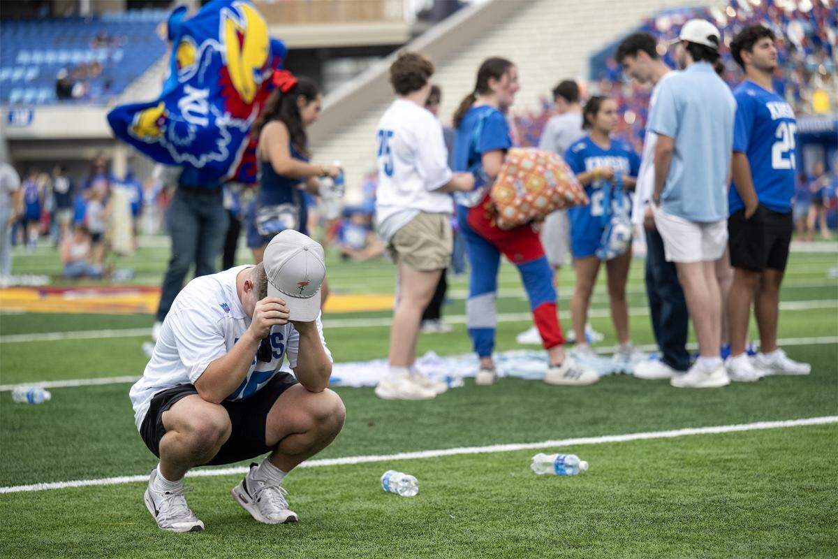 Kansas Jayhawks fan Javen Arndt of Emporia, a freshman, hung his head as the Jayhawks lost to the Missouri Tigers in the Border War showdown. Arndt and other Kansas fans watched the game on the Jumbotron Saturday, September 6, 2025 at the new David Booth Kansas Memorial Stadium in Lawrence.