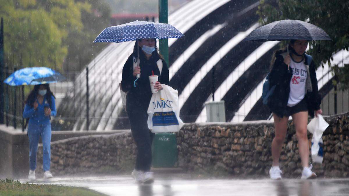 As rain fell Tuesday morning in Kansas City, students on the campus of UMKC broke out their umbrellas for the trek to classes. Forecasters are calling for the rain to end by early afternoon. There is a slight chance for more isolated thunderstorms on Wednesday, with a high expected to be in the mid 80s.