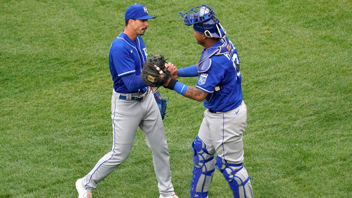Kansas City Royals relief pitcher Kyle Zimmer, left, celebrates with catcher Salvador Perez after the Kansas City Royals defeated the Chicago White Sox in a baseball game in Chicago, Sunday, April 11, 2021. (AP Photo/Nam Y. Huh)