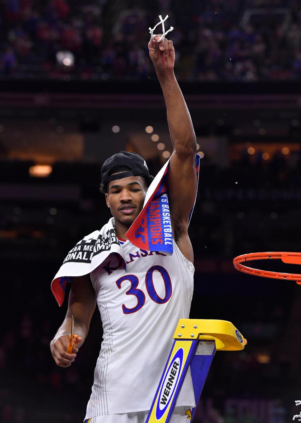 KU senior Ochai Agbaji waved to the crowd after cutting his piece of the net after the Jayhawks beat North Carolina, 72-69 Monday night in New Orleans to claim the NCAA championship.