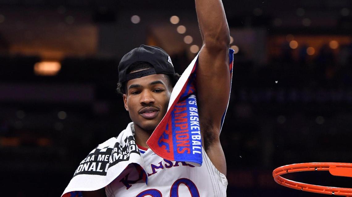 Kansas star Ochai Agbaji waved to the crowd after cutting a piece of the net following the Jayhawks’ 72-69 win over North Carolina in the 2022 NCAA Tournament championship game.
