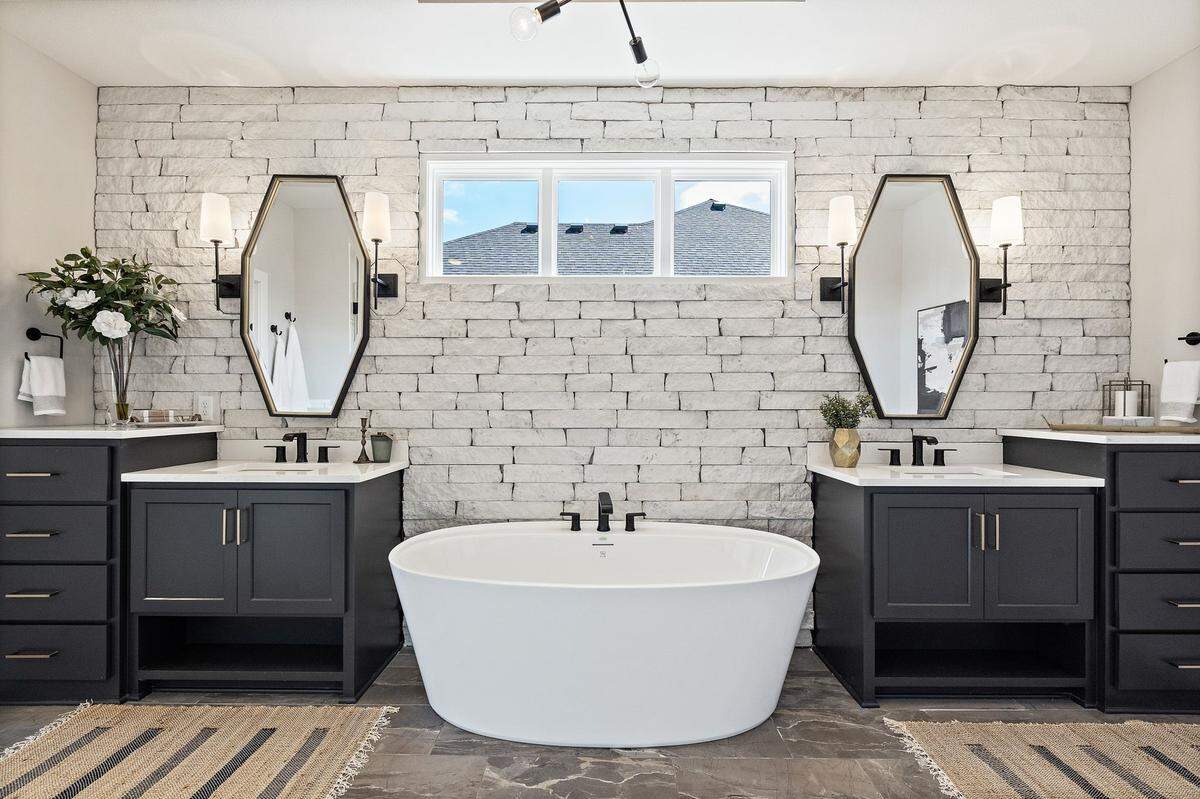 Justin Pfeifer’s favorite feature of the home at 329 NW Ambersham Drive in Lee’s Summit is this bathroom with a freestanding tub and split vanities.