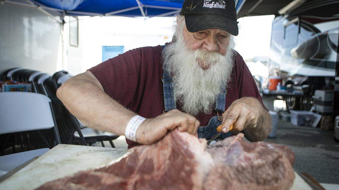 Jay Vantuyl cuts fat off a large brisket, which he estimates to be between sixteen and eighteen pounds, at the American Royal World Series of Barbecue Saturday, Sept. 14, 2019, at Kansas Speedway.