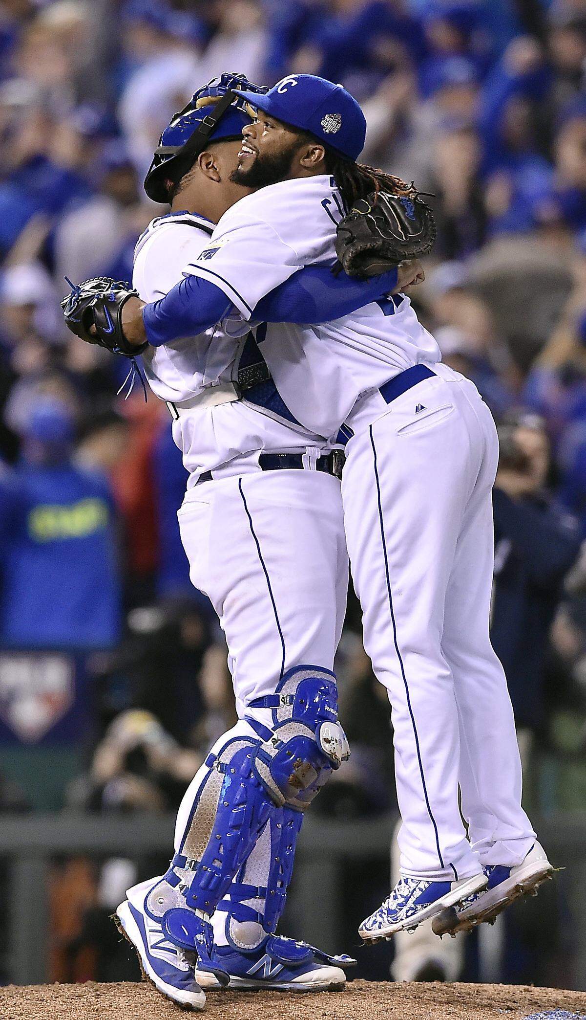 Kansas City Royals catcher Salvador Perez gives Kansas City Royals starting pitcher Johnny Cueto a big hug after Cueto pitched a complete game two-hitter to defeat the New York Mets 7-1 in Game 2 of the World Series on Wednesday, October 28, 2015 at Kauffman Stadium in Kansas City, Mo.