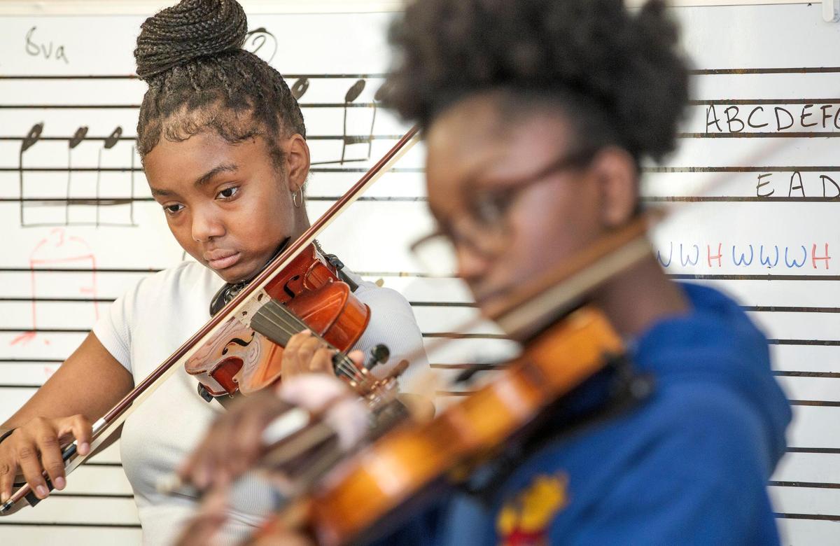 Hope Andrews, 14, played her violin during a strings practice session for the A-Flat Youth Orchestra Saturday, May 31, at Jamison Memorial Temple CME Church in Kansas City.