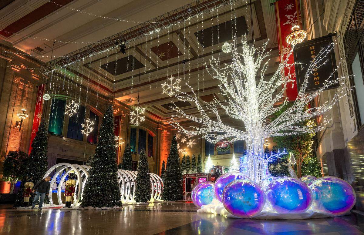 The 20-foot tall enchant tree is illuminated as final touches were being put on “Holiday Reflections” at Union Station on Thursday, November 20, 2025, in Kansas City. The exhibit opens Friday, November 21 and runs through January 4, 2026.