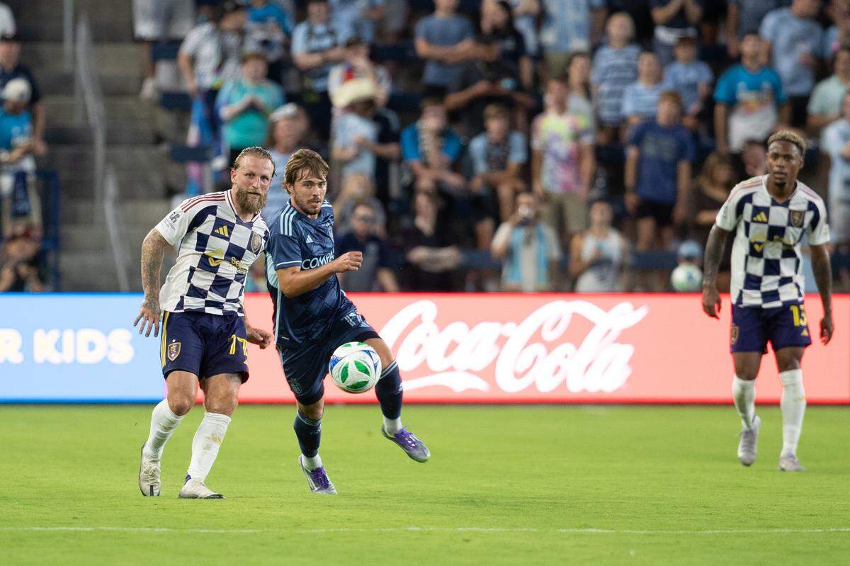 Real Salt Lake forward Johnny Russell (77) and Sporting Kansas City midfielder Jake Davis (17) compete for a ball at Children’s Mercy Park on June 28, 2025.