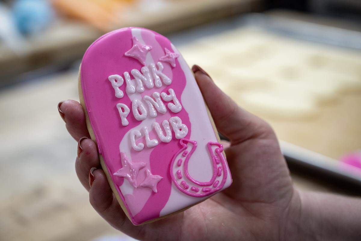 Olivia Lynn projected a design onto a Chappell Roan-themed sugar cookie which iced onto a cookie on Thursday, Oct. 2, 2025, at McLain's Bakery in Waldo. Local bakeries are seeing a significant demand for cookies to celebrate pop stars Taylor Swift and Chappell Roan.