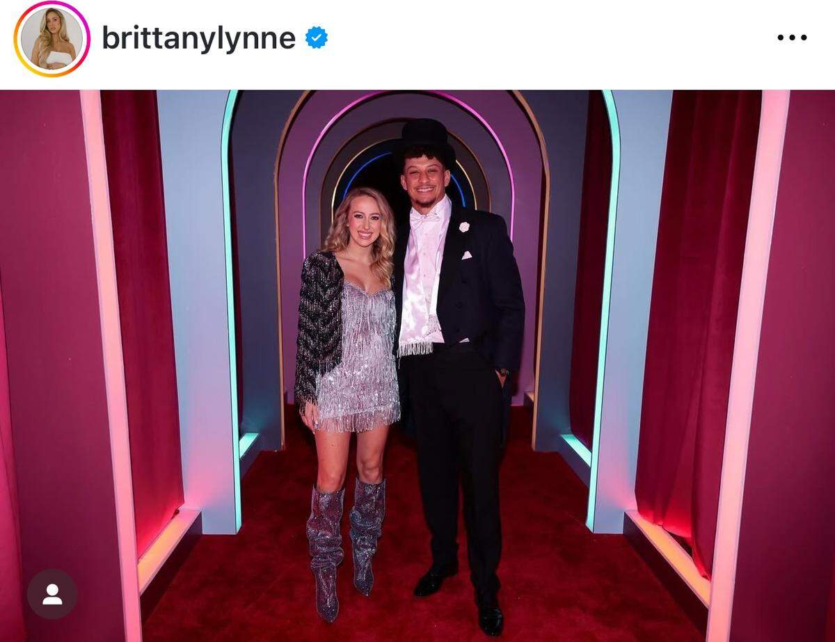 Brittany Mahomes and husband Patrick Mahomes, who is wearing a tux and top hat like the costume worn in “The Tortured Poets Department” set of Swift’s Eras Tour.