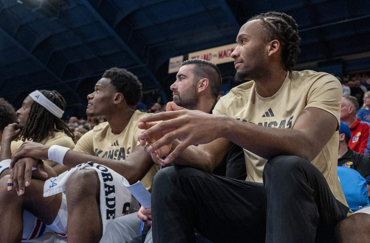 Kansas Jayhawks guard Darryn Peterson (22) right, watches the game against Texas A&M-CC Islanders from the bench at Allen Fieldhouse on Tuesday, November 11, 2025, in Lawrence. Peterson is out with a tight hamstring.
