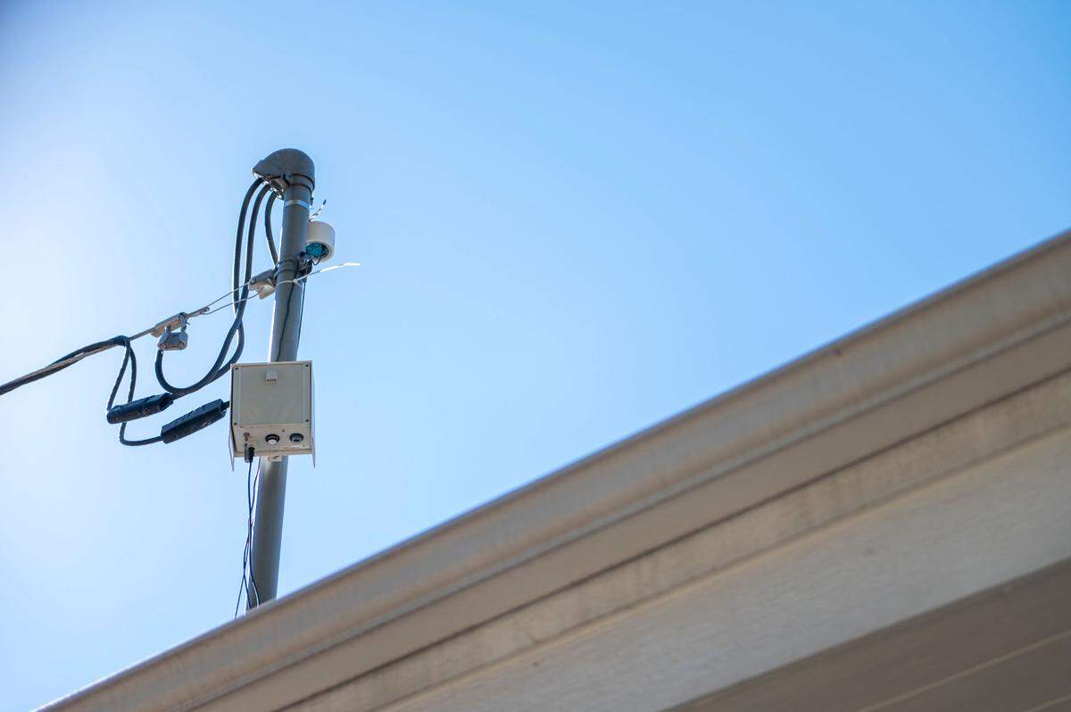 An air monitor sits on top of the roof of Genesis Child Care and Home on Monday, Oct. 17, 2022, in Kansas City, Kan. Owner Ivonne Gutierrez says that she installed the monitor to help her see when pollution levels are lower, making it safer for the kids she cares for to spend time outside.
