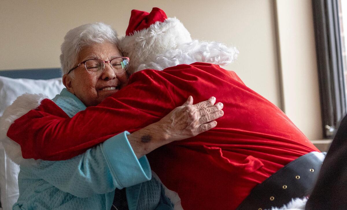 Liberty Hospital patient Marietta Wimmer enjoyed a hug from Santa this week. “He’s a nice Santa. He looks good, too. He looks real,” she said of hospital employee Rob Kinnard, who plays Santa.