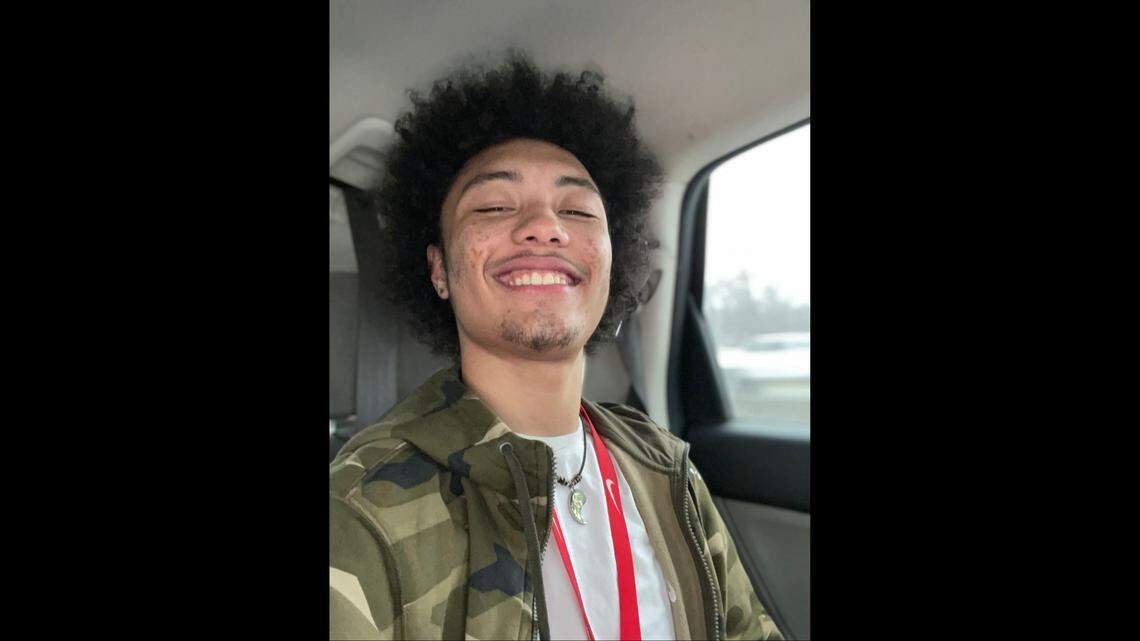 Jaden smiles taking a selfie in car.