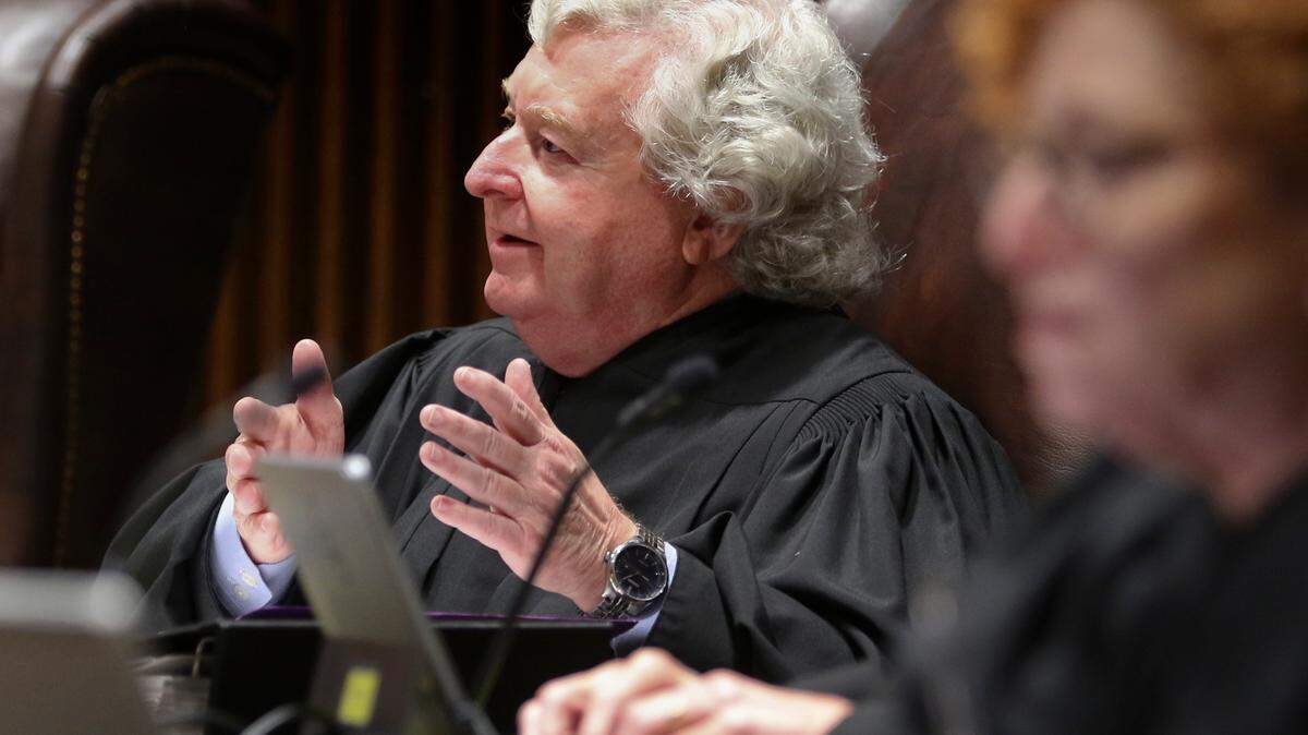 Kansas Supreme Court Justice Dan Biles asks Attorney General Derek Schmidt a question during arguments Monday morning.