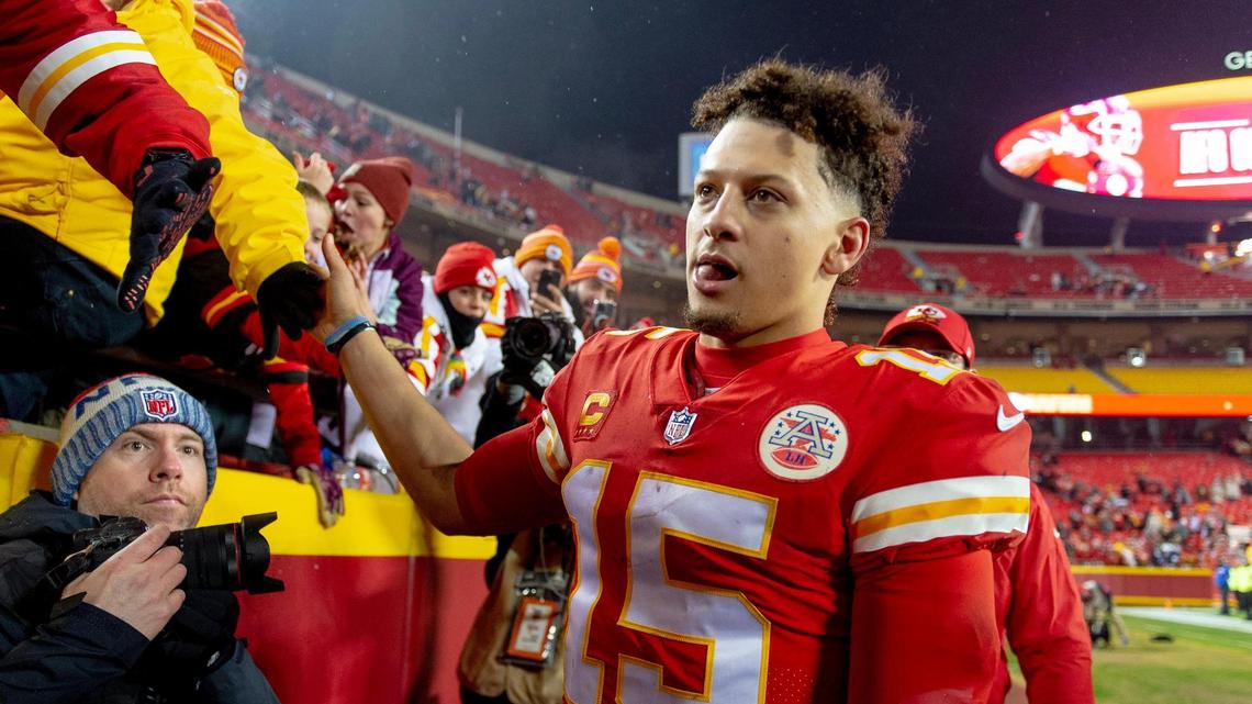 Kansas City Chiefs quarterback Patrick Mahomes (15) high fives fans after an NFL divisional round playoff game against the Jacksonville Jaguars at GEHA Field at Arrowhead Stadium on Saturday, Jan. 21, 2023, in Kansas City.