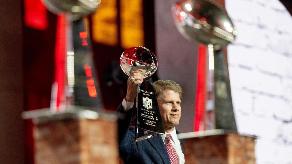 Kansas City Chiefs owner Clark Hunt hoists one of three Lombardi Trophies belonging to the Chiefs organization before announcing the team’s first round pick during the NFL Draft outside of Union Station on Thursday, April 27, 2023, in Kansas City.