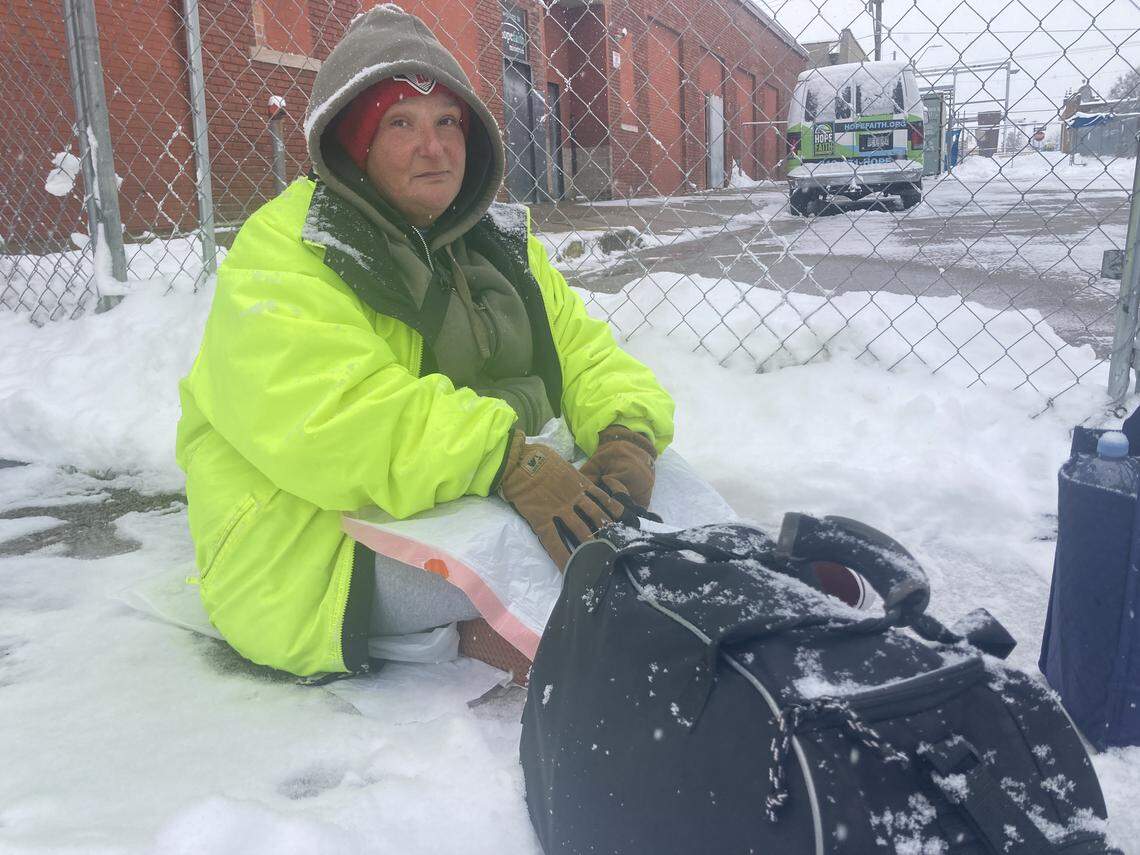 Lisa Gharst, 45 and houseless, waits in the snow for the Hope Faith Ministries Homeless Assistance Campus, 705 Virginia Avenue, to open its doors where its overnight shelter is now accommodating women. The overnight shelter opened on Dec. 1.