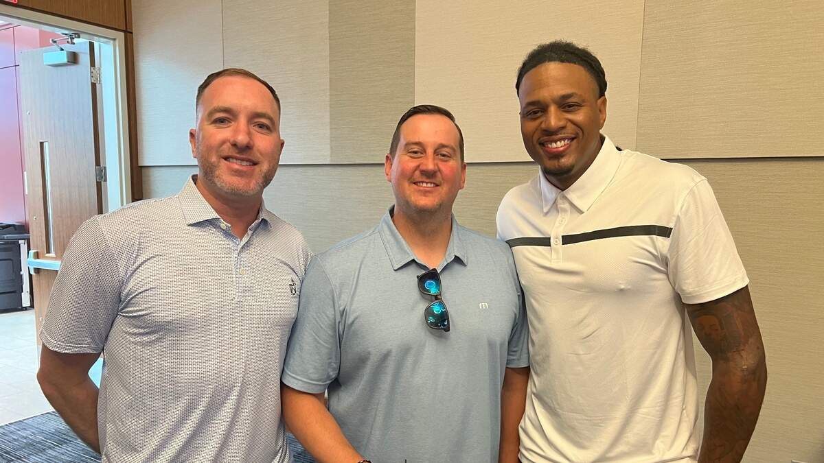 Former NCAA and NBA champion Brandon Rush, right, poses for a picture with 2008 title teammates Brady Morningstar and Brad Witherspoon at the Rock Chalk Roundball Classic banquet on June 9, 2023.