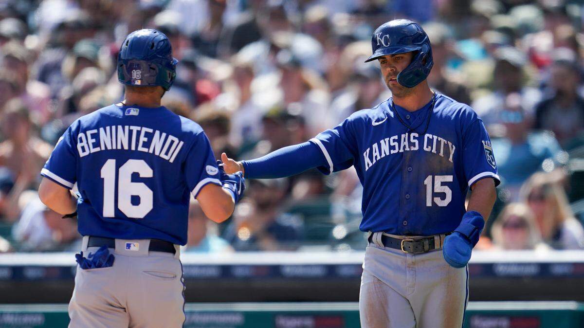 Kansas City Royals’ Andrew Benintendi (16) and Whit Merrifield (15) celebrate scoring against the Detroit Tigers in the first inning of a baseball game in Detroit, Saturday, July 2, 2022. (AP Photo/Paul Sancya)