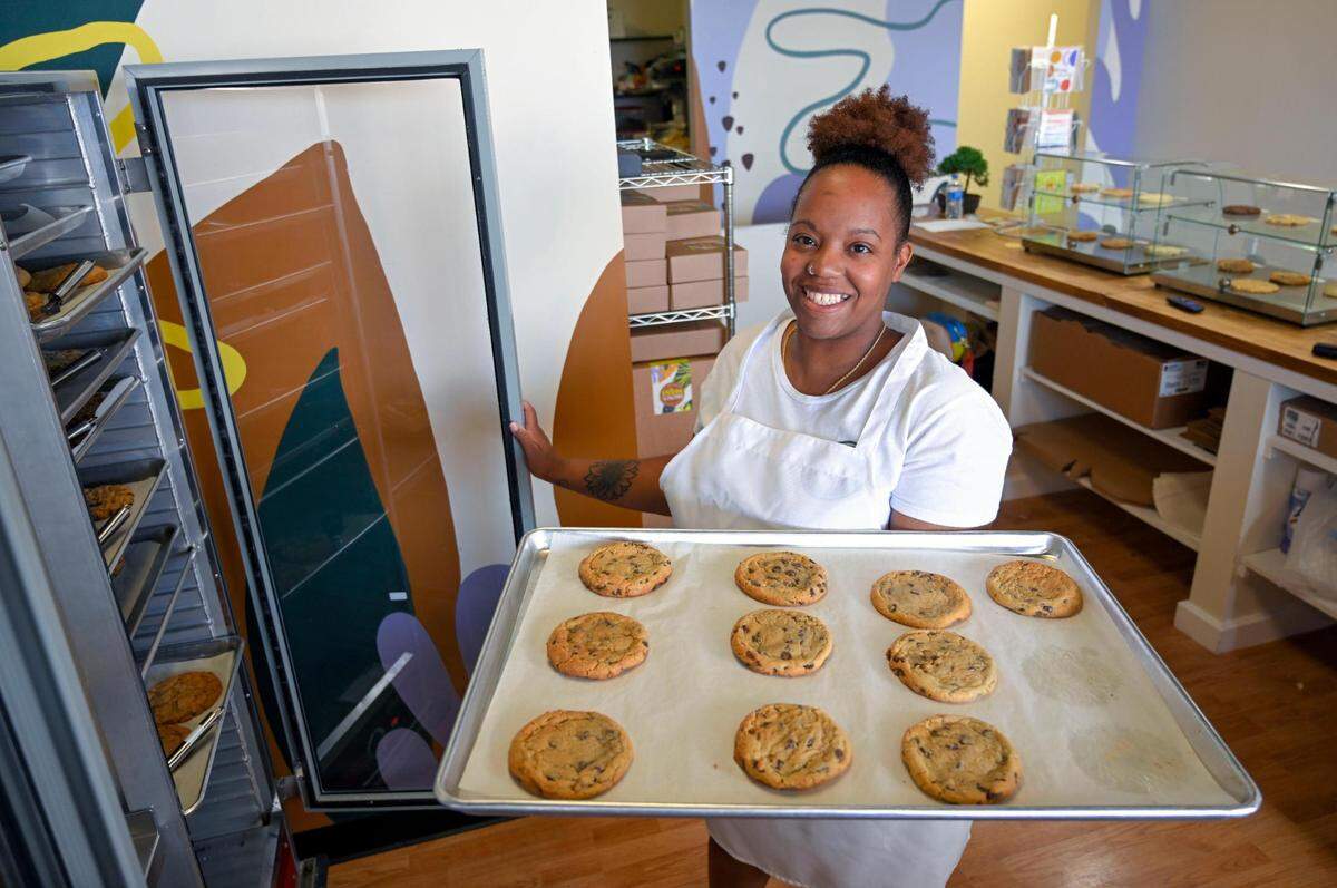 Asia Lockett, one of three owners of Brown Suga, was busy filling orders for cookies in June 2023, at the cookie shop in Olathe.