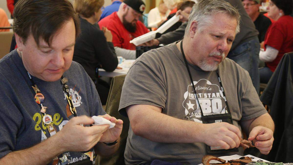 Judges Jeff Dean of Shawnee and Jeff Vonfeldt of Olathe sample some of the brisket entries from the 2019 competition.