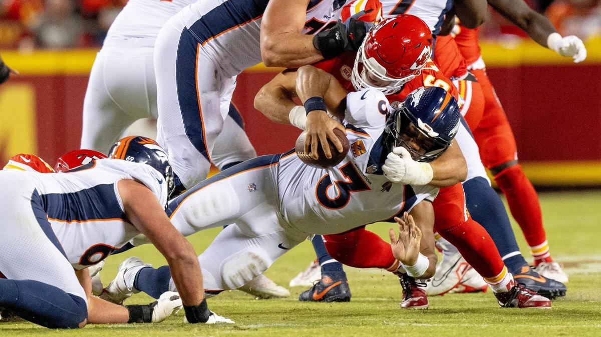 Kansas City Chiefs defensive end George Karlaftis (56) sacks Denver Broncos quarterback Russell Wilson (3) during an NFL football game at GEHA Field at Arrowhead Stadium on Thursday, Oct. 12, 2023, in Kansas City.