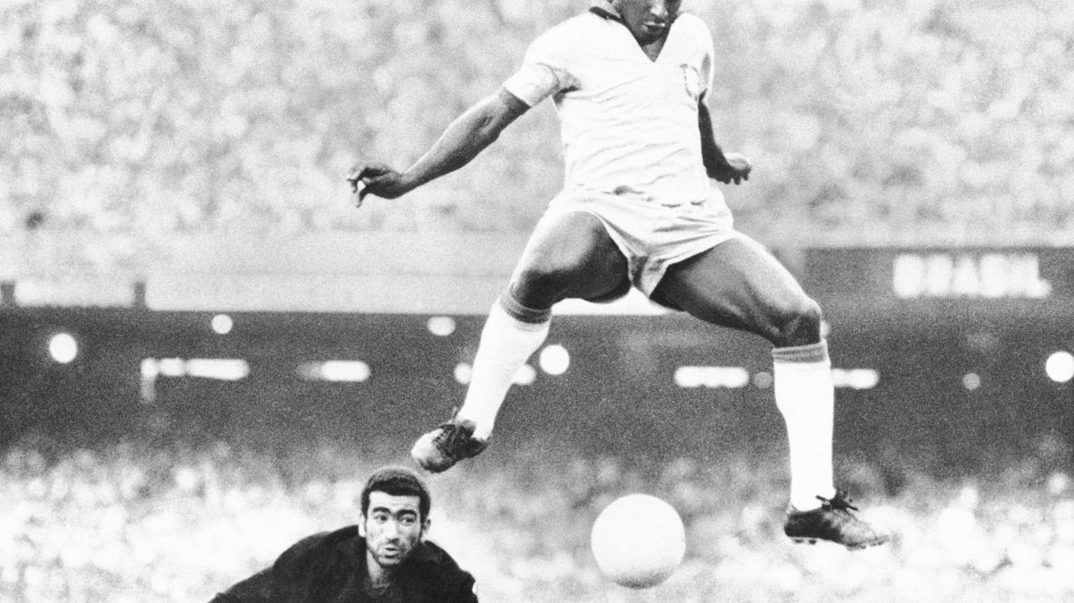 Brazil’s Pele leaps and scores past Venezuela goalkeeper Fabrizio Fasano during a 1969 match in Rio de Janeiro, Brazil.