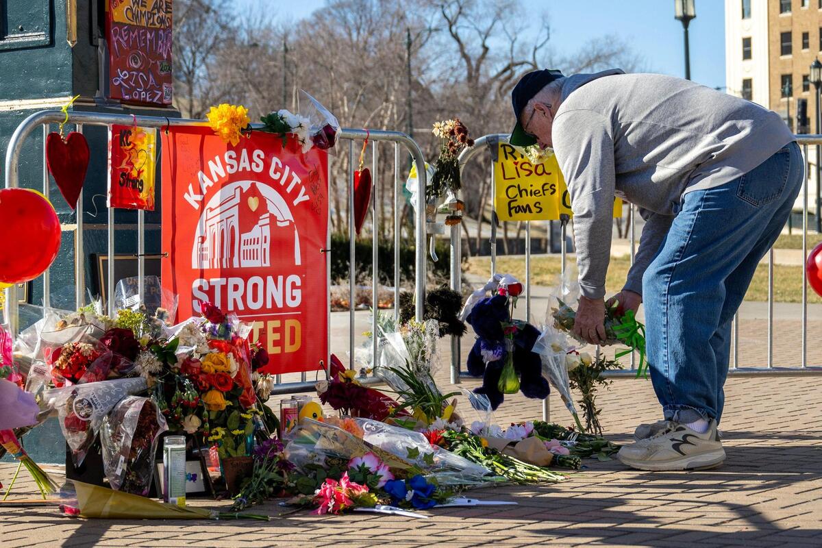 Gary Egger leaves flowers at a makeshift memorial for Lisa Lopez-Galvan at Union Station Feb. 18 after she was killed in in a hail of gunfire at the Kansas City Chiefs Super Bowl rally.